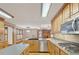 This kitchen has granite countertops, wooden cabinets and stainless steel appliances at 2705 Luke Edwards Rd, Dacula, GA 30019