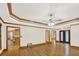 Spacious living room featuring hardwood floors, ceiling fan, and elegant trim at 2705 Luke Edwards Rd, Dacula, GA 30019