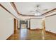 Spacious living room featuring hardwood floors, tray ceilings, and double doors that open to the entryway at 2705 Luke Edwards Rd, Dacula, GA 30019