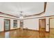 Living room with hardwood floors, tray ceiling, and access to a porch and other rooms at 2705 Luke Edwards Rd, Dacula, GA 30019