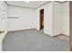 View of an unfinished room with painted concrete floors, white walls, and a closet at 2705 Luke Edwards Rd, Dacula, GA 30019