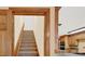 View of a carpeted staircase with wooden trim, adjacent to an open kitchen with wood cabinetry at 2705 Luke Edwards Rd, Dacula, GA 30019
