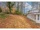 Spacious backyard featuring tall trees and a sunroom addition to the house at 2800 Kingston Ter, Atlanta, GA 30344