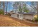 View of house from the backyard, featuring a long sunroom addition on the home at 2800 Kingston Ter, Atlanta, GA 30344