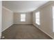 Spacious bedroom with neutral walls, carpeted floors, and natural light from windows at 2800 Kingston Ter, Atlanta, GA 30344