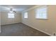 Bedroom with neutral walls, carpeted floors, a ceiling fan, and ample natural light from two windows at 2800 Kingston Ter, Atlanta, GA 30344