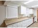 Kitchen area with granite countertops, white cabinets, and stainless steel dishwasher at 2800 Kingston Ter, Atlanta, GA 30344