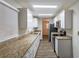 Galley kitchen featuring white cabinetry, granite countertops, and stainless steel appliances at 2800 Kingston Ter, Atlanta, GA 30344