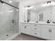 This modern bathroom includes a double vanity, a glass shower, and modern finishes at 2980 Ferrington Way, Smyrna, GA 30080