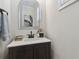 Elegant powder room with a decorative mirror, modern vanity, and neutral color palette at 2980 Ferrington Way, Smyrna, GA 30080