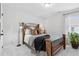 A cozy bedroom with a bed with wooden accents and a plant near the window at 2980 Ferrington Way, Smyrna, GA 30080