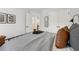 A neatly made bed with brown throw pillows and art decorated in the bedroom at 2980 Ferrington Way, Smyrna, GA 30080