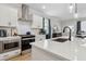 Close-up of kitchen island with quartz countertops, stainless steel appliances, and pendant lights at 2980 Ferrington Way, Smyrna, GA 30080