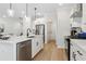 Bright kitchen featuring an island with a sink, stainless steel appliances, and modern pendant lighting at 2980 Ferrington Way, Smyrna, GA 30080