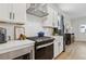 Modern kitchen featuring white cabinets, stainless steel appliances, and a stylish backsplash at 2980 Ferrington Way, Smyrna, GA 30080