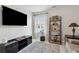 A living room area with entertainment center, shelving, and a leather couch at 2980 Ferrington Way, Smyrna, GA 30080