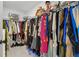 Large walk-in closet filled with hanging clothes and storage for accessories at 2980 Ferrington Way, Smyrna, GA 30080