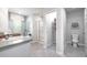 Well-lit bathroom with a glass-enclosed shower, spacious vanity, and walk-in closet at 221 Friendship Oak Way, Hampton, GA 30228