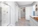 Bright bathroom boasts glass shower, access to walk-in closet, and modern fixtures at 221 Friendship Oak Way, Hampton, GA 30228