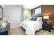 Serene bedroom with a cozy bed, bedside tables, a window and neutral-colored walls at 221 Friendship Oak Way, Hampton, GA 30228