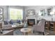 The living room features a fireplace with a mantle, a sofa with decorative pillows, and an area rug at 221 Friendship Oak Way, Hampton, GA 30228