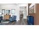 Inviting living room with wood flooring, elegant furnishings and an open view to the dining area at 221 Friendship Oak Way, Hampton, GA 30228