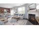 This bright living room features a cozy seating area with a fireplace, a dining room, and hardwood floors at 221 Friendship Oak Way, Hampton, GA 30228