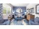 Comfortable living room with stylish decor, a large window and an elegant chandelier at 221 Friendship Oak Way, Hampton, GA 30228