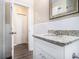 Bathroom featuring a granite countertop, white cabinets, and neutral flooring at 2328 Starline Dr, Decatur, GA 30032