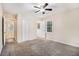 Spacious bedroom with neutral carpet, ceiling fan, and a large window at 2328 Starline Dr, Decatur, GA 30032