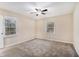Spacious bedroom featuring neutral carpet, a ceiling fan, and two bright windows at 2328 Starline Dr, Decatur, GA 30032