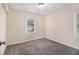 Cozy bedroom featuring neutral walls and carpet with bright natural lighting at 2328 Starline Dr, Decatur, GA 30032
