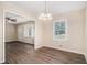 Dining room with hardwood floors, a modern chandelier, and views into the living area at 2328 Starline Dr, Decatur, GA 30032