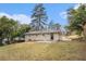 Rear exterior view of a house with a grassy yard and mature trees at 2328 Starline Dr, Decatur, GA 30032