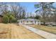 A single-story home with a long driveway, showcasing its classic and simple design at 2328 Starline Dr, Decatur, GA 30032