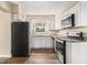 A modern kitchen with white cabinetry, stainless steel appliances, and granite countertops at 2328 Starline Dr, Decatur, GA 30032