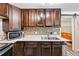 Modern kitchen with stainless steel sink, faucet, mosaic backsplash, wooden cabinets, and modern countertops at 2557 Sixes Rd, Canton, GA 30114