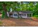 A fixer upper home with mature trees and large frontage road access at 1491 S Hairston Rd, Stone Mountain, GA 30088