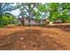 View of a home with boarded up windows sitting on a treed lot at 1491 S Hairston Rd, Stone Mountain, GA 30088