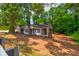 A fixer upper home with mature trees and large frontage road access at 1491 S Hairston Rd, Stone Mountain, GA 30088