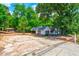 A fixer upper home with mature trees and large frontage road access at 1491 S Hairston Rd, Stone Mountain, GA 30088