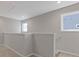 Upstairs hallway with carpet, staircase, railing and large windows at 1985 William Glen St, Dacula, GA 30019