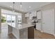 Modern kitchen featuring an island, stainless steel appliances, and a large window for natural light at 1985 William Glen St, Dacula, GA 30019