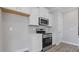 Well-equipped kitchen with stainless steel appliances, white cabinets, and subway tile backsplash, with a door on the side at 1985 William Glen St, Dacula, GA 30019