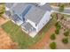 Rear view showing fenced yard, attached garages, and small covered patios at 1985 William Glen St, Dacula, GA 30019