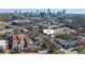 An aerial view of townhomes surrounded by trees, city skyline in the background, and easy access to nearby urban amenities at 3535 Roswell Ne Rd # H2, Atlanta, GA 30305
