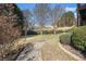 A well-maintained backyard walkway and landscaping lead toward a beautiful treed view at 461 Wynns Way, Atlanta, GA 30331