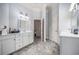 Bright bathroom with double vanities, tiled floor, and natural light at 461 Wynns Way, Atlanta, GA 30331