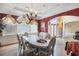 Elegant dining room with a tray ceiling, chandelier, and decorative window treatments at 461 Wynns Way, Atlanta, GA 30331