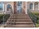A stately brick entrance staircase leading to a home with arched windows and glass front doors at 461 Wynns Way, Atlanta, GA 30331